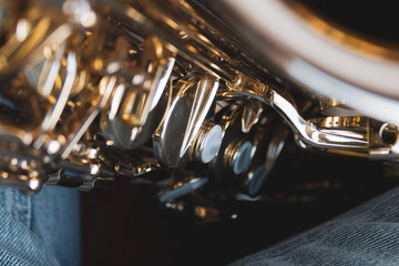 Alto sax musical instrument closeup. Gold saxophone.