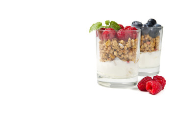 muesli dessert with yogurt and blueberry in a glass over white background. Granola in glass with berries and yogurt.