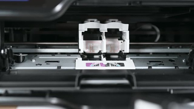 printer detail moves and person hand fixes ink container into special metal box at technique support service close view