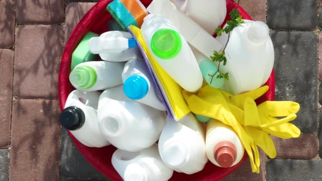 different cleaning products, Cleaning supplies, group of colorful plastic bottles outdoor, Basket with cleaning items, House cleaning service and housekeeping concept, zoom and blurred