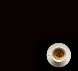 top view of white cup of coffee on a dark black background.