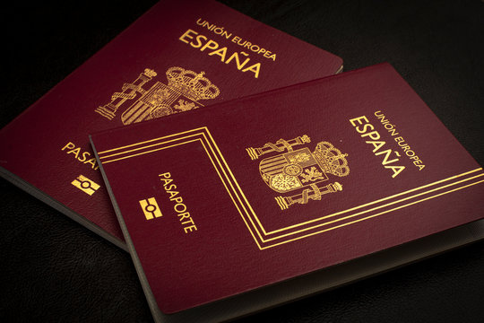 Buenos Aires, year 2020: Spain passport of the European Union. Travel documents. Espa&ntilde;a country, spanish language. Black background.