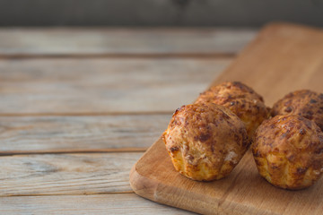 Fresh pastry. Homemade muffins on white wooden table background with copyspace.