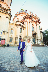 bride and groom walk around the old town