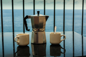 Coffee maker in front of the sea