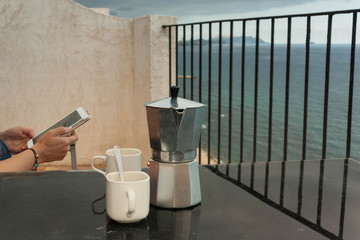 Reading in front of the sea after a cup of coffee