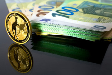 Australian Kangaroo - a gold coin placed on money valid in the European Union worth 100 euros. The Golden Age - Gold replace paper Money.