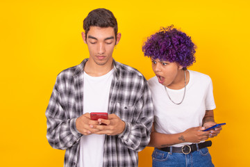 isolated young couple looking at mobile phone or spying