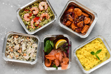 Different aluminium lunch box with healthy meals for lunch. Healthy food restaurant dish delivery. Take away fitness food. top view
