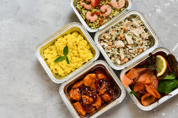 Different aluminium lunch box with healthy meals for lunch. Healthy food restaurant dish delivery. Take away fitness food. top view