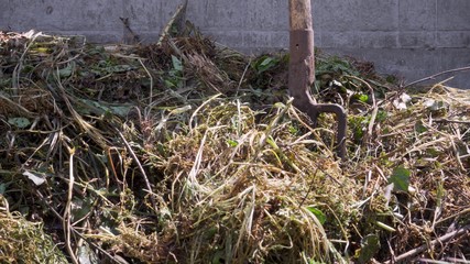 A compost heap in the backyard. Organic fertiliser of garden plants.