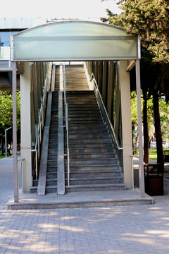 Stairs of pedestrian overpass. Image of footbridge. Indoor elevated pedestrian crossing