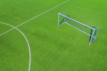 a soccer goal on an empty soccer field from above