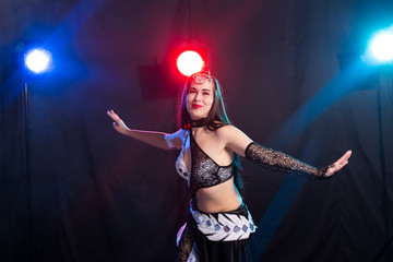 Portrait of a woman in oriental costume performing belly dance. Tribal fusion dance concept.