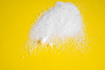 white powder salt crystals chemistry on a yellow background place for text