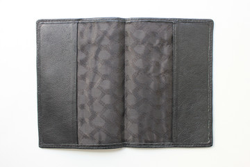 Black leather cover for passport or other documents. Open old natural leather material cover, close up view isolated on empty white background