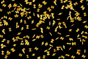 Italian flying raw pasta isolated on black background. macaroni falling.