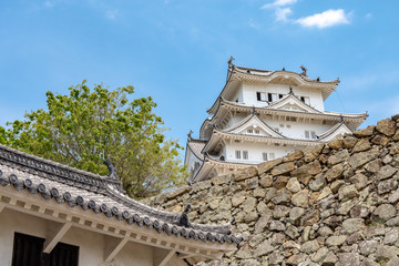 Fototapeta premium Himeji, Japan - May 06, 2019: Main tower of the Himeji Castle, the white Heron castle, Japan. UNESCO world heritage site after restauration and reopening.