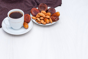 Healthy breakfast or snack concept. Black coffee, dried fruits. Copy space.