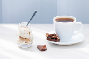 Cup of coffee, milk chocolate with nuts, ice cream with chocolate powder. Summer eat and drink for...