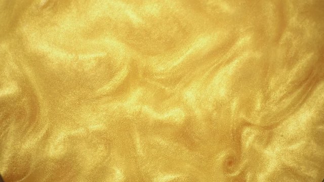 Yellow paint texture abstract background. Flowing Golden glitter