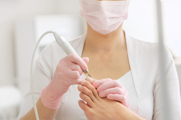 Patient on medical pedicure procedure, visiting podiatrist.Professional hardware pedicure using...