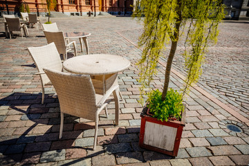 Empty summer terace tables in old town of city. Open air Cafe