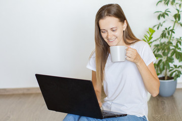 Happy young woman working office at home using computer.