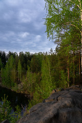 View of a rocky cliffs of lake shore in the forest