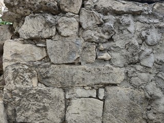 Old wall of large and small natural stone