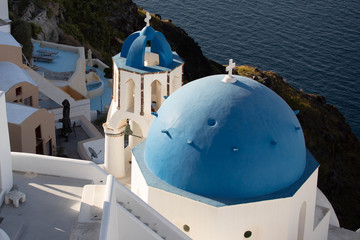 old fishing boat in front of church in santorini greece