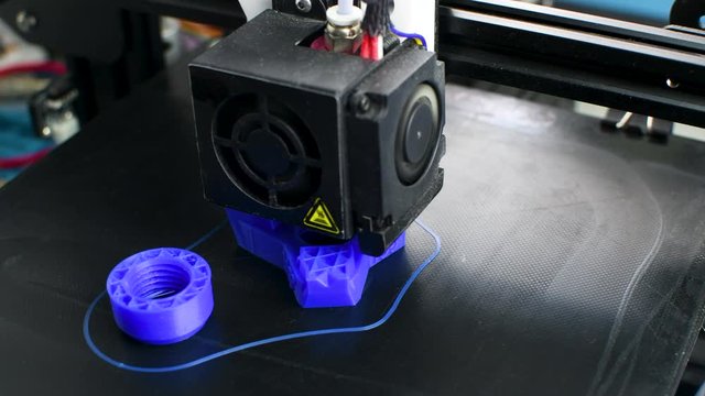 The 3D printer printed blue plastic model. modern technology