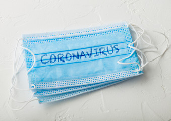 Medical face mask with coronavirus written on it on white background. Best protection from coronavirus, germs,bacteria and viruses. For hospital and every day use.