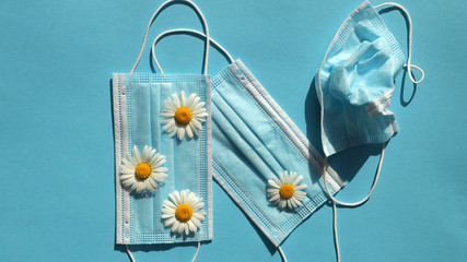 
medical mask with flowers on a blue background