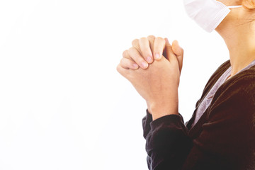Young woman in hygienic mask are praying  in the morning.