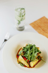tofu, arugula, sesame seeds, sweet and sour sauce, vegetables, bell pepper and lemonade nearby