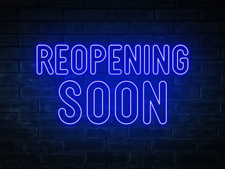 Fototapeta na wymiar Reopening soon - blue neon light word on brick wall background 