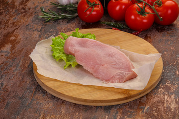 Raw Turkey steak served rosemary