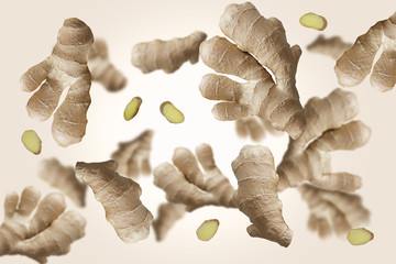 Falling ginger root isolated on a colored background with clipping path as package design element...