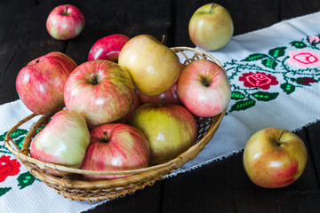 Apples in a basket and honey on a black background.