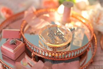 The details of the wedding morning: bride's earrings, flowers, decorations, ribbon, etc.