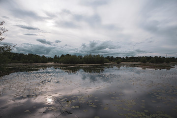 Rain clouds approaching above secluded lake near Zagreb city, Croatia
