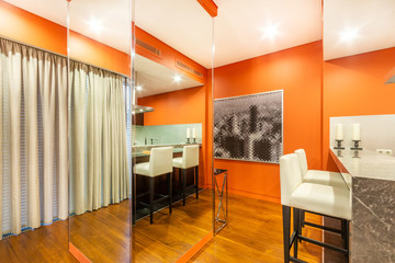New kitchen with a marble counter and high white chairs