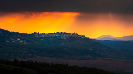 Beautiful bright sunset over the hill town of Montalcino. Val d'Orcia, Tuscany, Italy