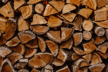 A bunch of wooden hacked firewood laying outside
