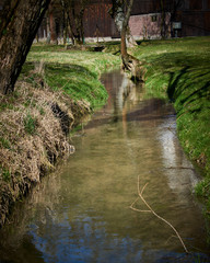 A quiet stream meanders around meadows and fields