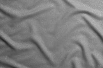 Black and white wavy silk fabric with folds. Mockup and blank designer for making a flag on a gray background.