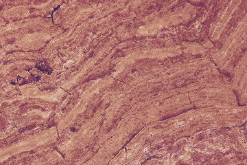Red marble stone background pattern or texture. Onyx texture of natural stone. Surface of the marble with red tint.