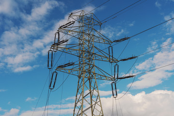 View of a power plant with many power lines on a background of beautiful cloudy sky