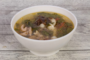 Thai style soup with meat and mushrooms